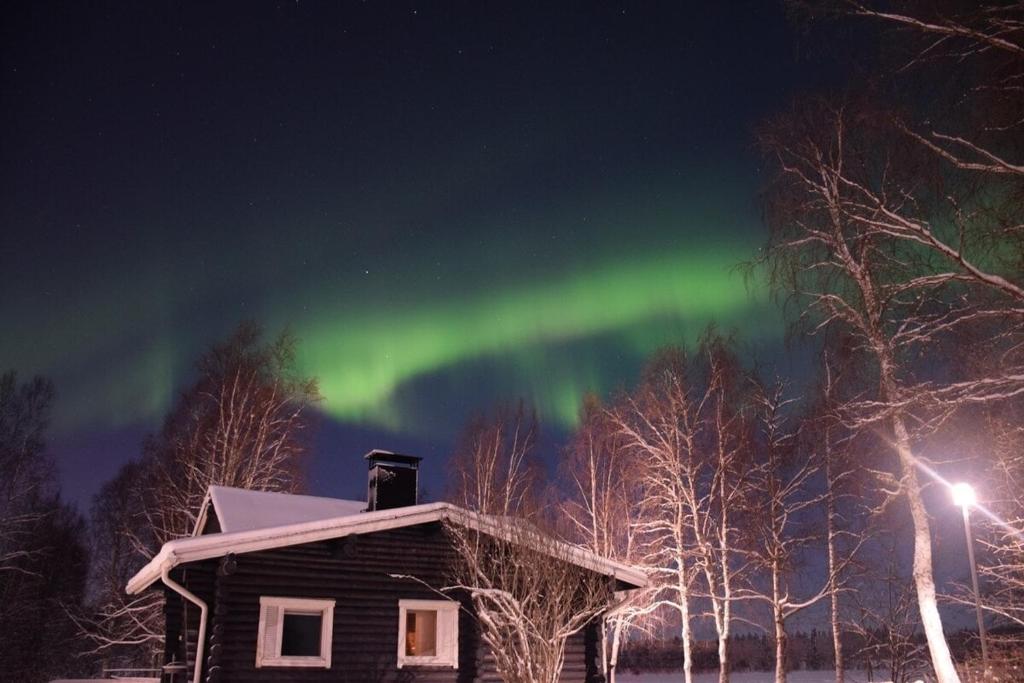 an image of the aurora in the sky over a house at Villa Hackberry Hill in Rovaniemi