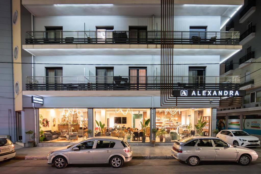two cars parked in front of a building at ALEXANDRA Boutique Residence Downtown in Alexandroupoli