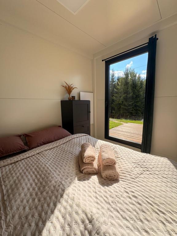 a bedroom with a bed with towels on it at Oravalley in Oravska Jasenica