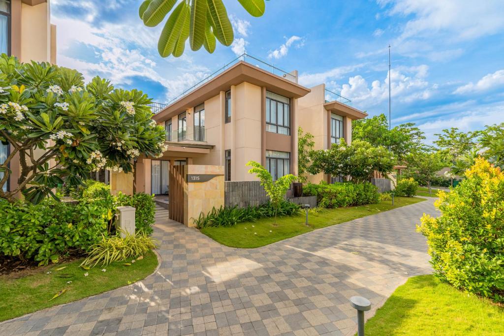 a house with a garden in front of it at Seaside Escape Villa in Cam Lâm