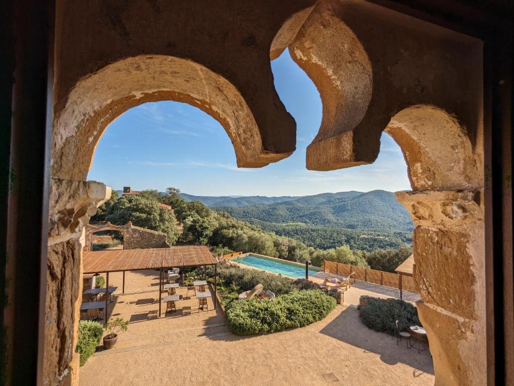 a view from a window of a resort with a pool at Mas Oms in Montnegre