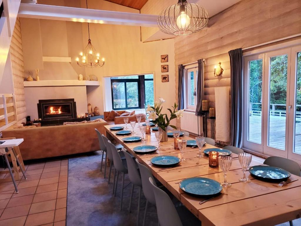 a large dining room with a long table and chairs at Gite de Liresse 