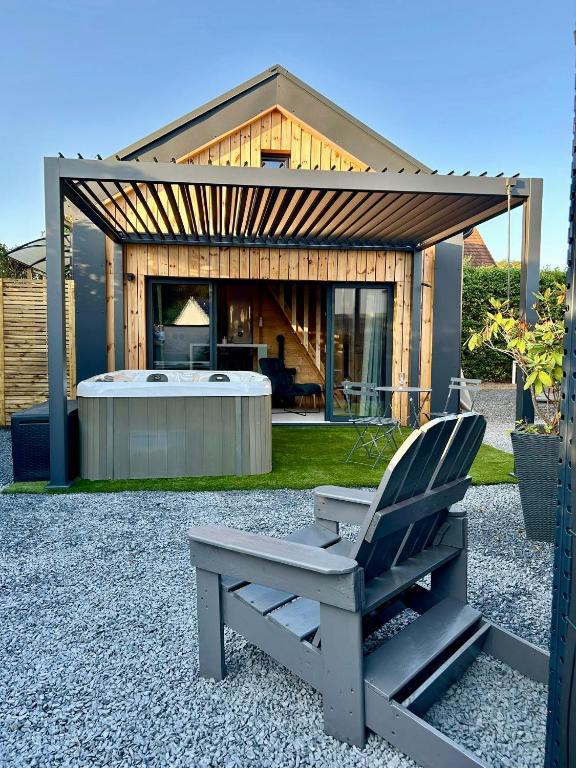 a chair and a tub in front of a house at Cosy Lodgy in Eslettes
