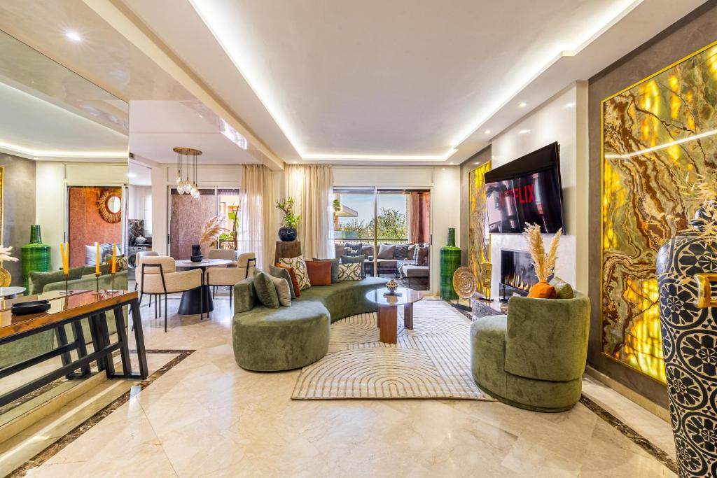 a living room with green furniture and a tv at Prestige 2BR in Marrakech