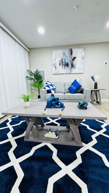a living room with a table and a couch at Comfort Escape, rooms in Charlotte with shared common spaces in Charlotte