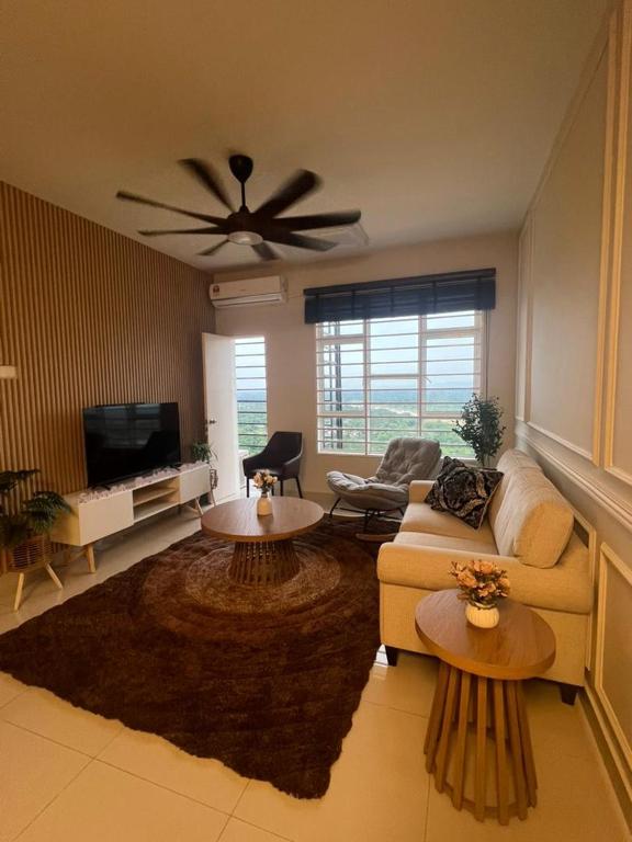 a living room with a couch and a ceiling fan at Sky28 - Sireh Residence in Kota Bharu