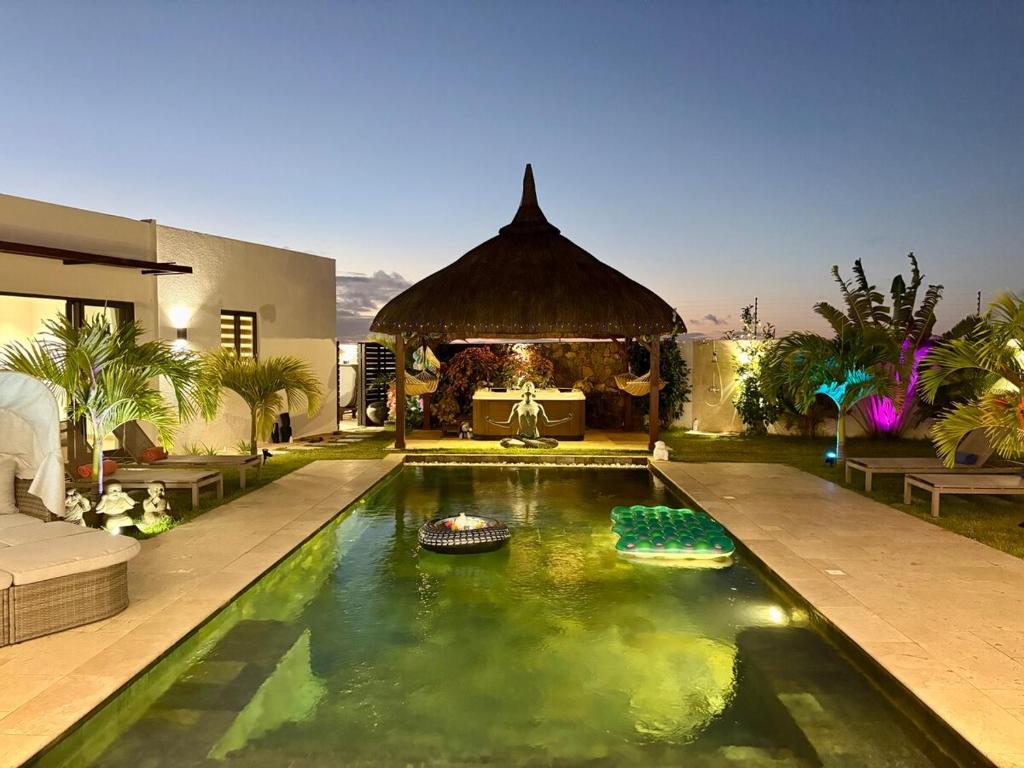 a swimming pool in the middle of a house at Zolikaz in Grand-Baie