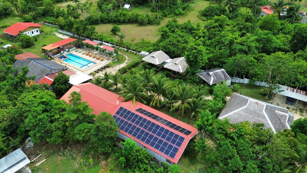 an aerial view of a house with a swimming pool at Casa James Apartment, Rooms , Pool and Restaurant in Siquijor