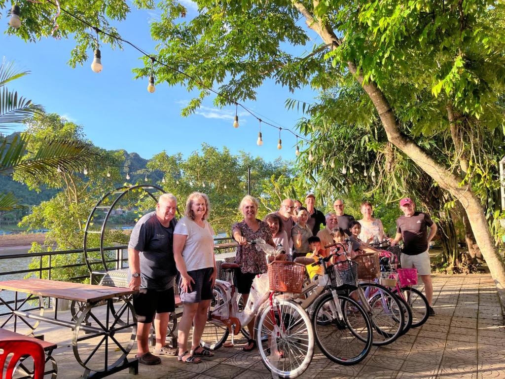 a group of people standing next to their bikes at Areca Bungalow in Phong Nha