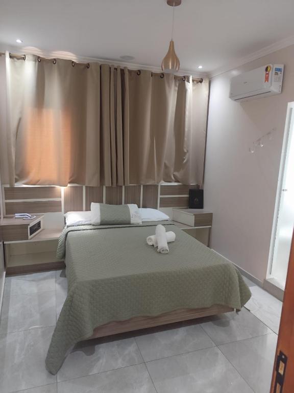 a bedroom with a bed with a stuffed animal on it at Hotel Prime Tatuapé - Próximo ao Metrô Belém - Café da Manhã Incluso e Estacionamento Econômico no Local in São Paulo