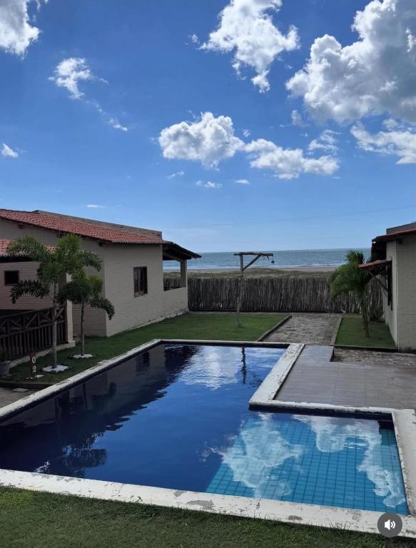 a swimming pool with a view of the ocean at Chalé do Comendador,Praia do Maceió-Camocim Ce in Camocim