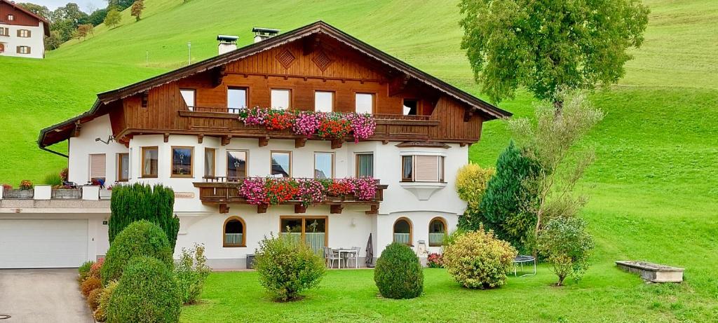 a house with flower boxes on the front of it at Ferienwohnung Seethaler - Gartenblick in Thiersee