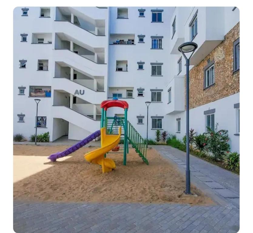 a playground in front of a apartment building at The Rittos in Mombasa