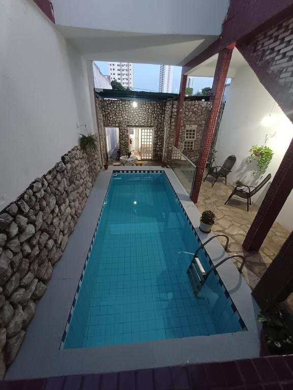 a swimming pool in the middle of a house at Hostel Goiabeiras in Cuiabá