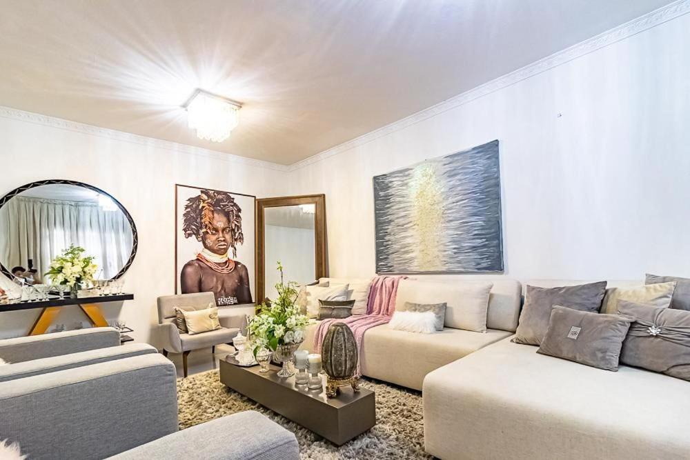 a living room with two couches and a table at CASA CONFORTÁVEL, 5 SUITES e 1 QUARTO in Belém