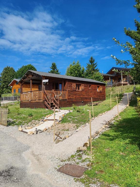 a log cabin with a path leading to it at Chalet dans le parc régional du Haut-Jura in Saint-Laurent-en-Grandvaux