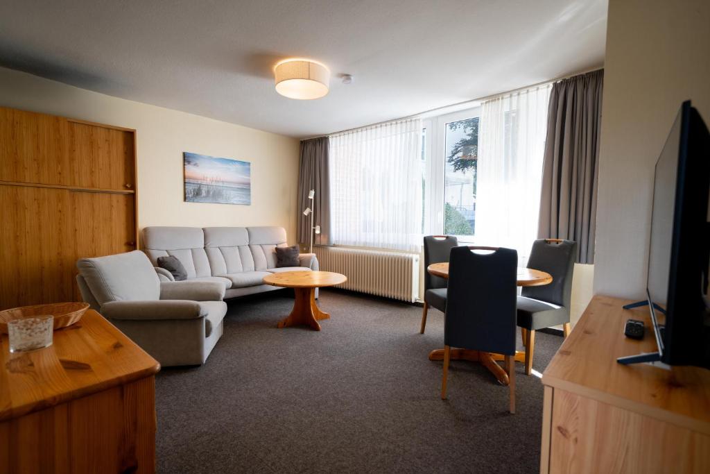 a living room with a couch and a table at Haus Sonnenwinkel Bungalow 3 in Dahme