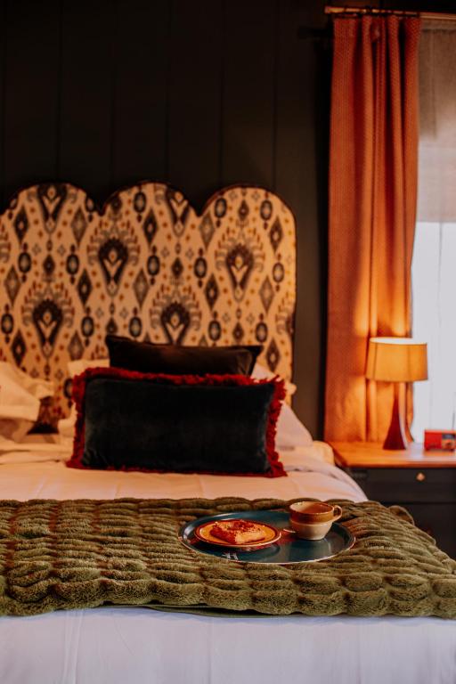 a tray with a plate of food on a bed at Slowley Farm in Watchet