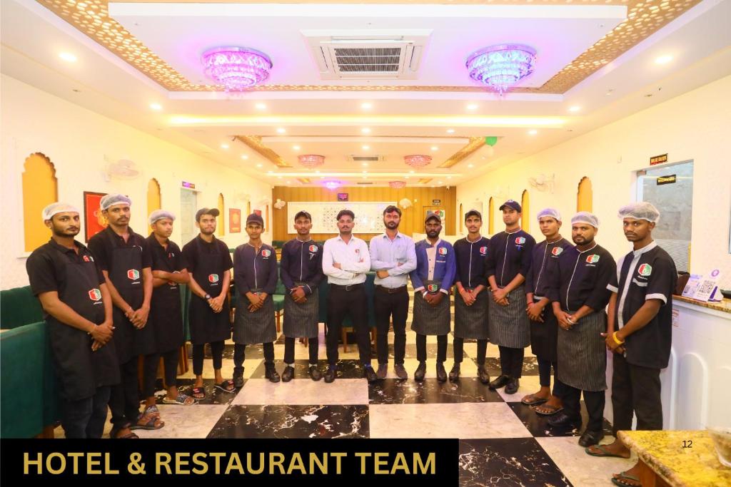 Un grupo de hombres posando para una foto en una habitación. en Hotel Shree Khodiyar By Rangoli Udaipur, en Udaipur