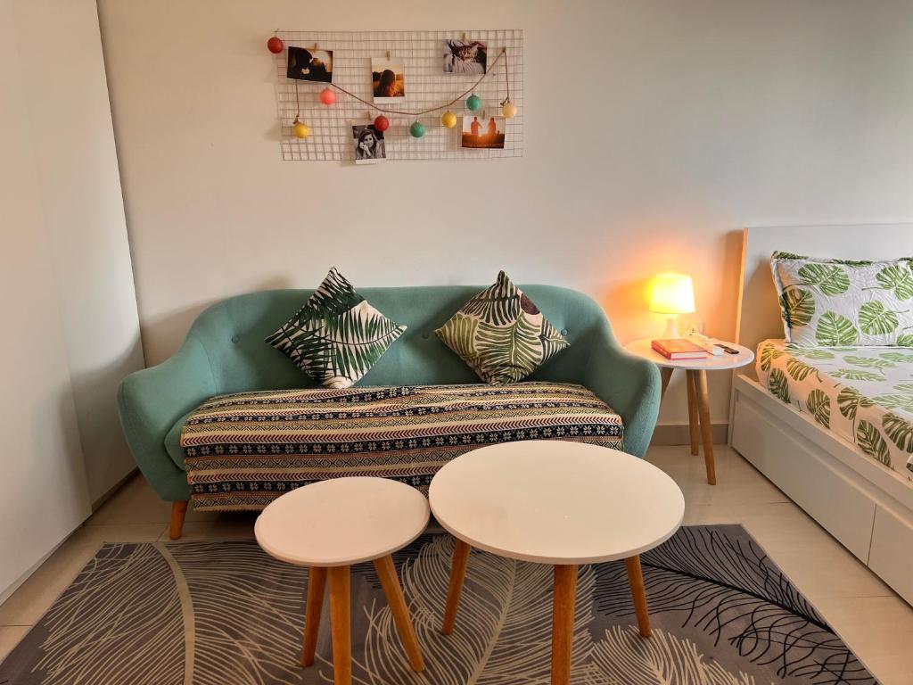 a living room with a couch and two tables at Vinhome Grand Park Homestay-HappyStay in Gò Công