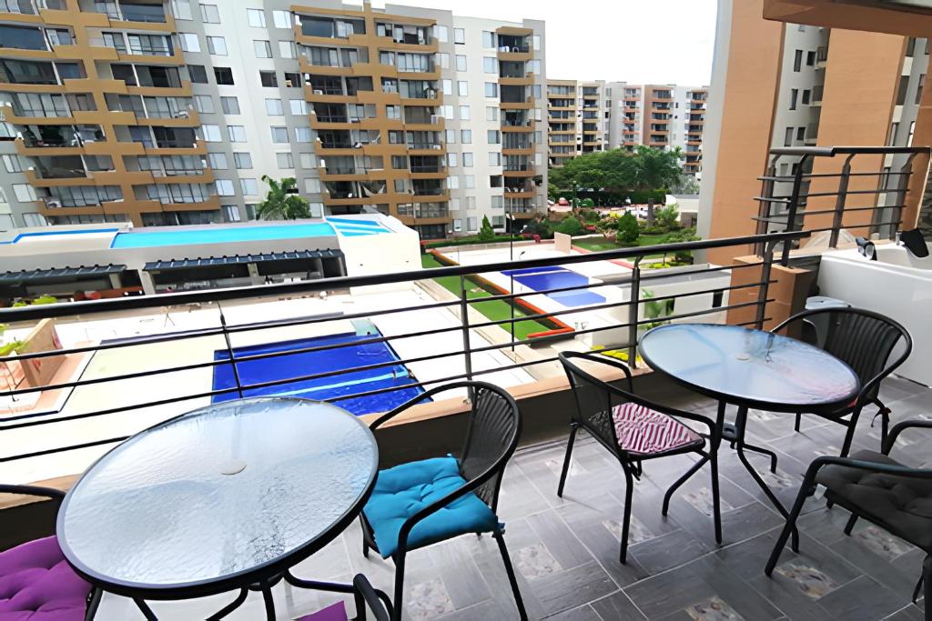 two tables and chairs on a balcony with buildings at Relax en Ricaurte, Jacuzzi privado, 94 Mts in San Rafael