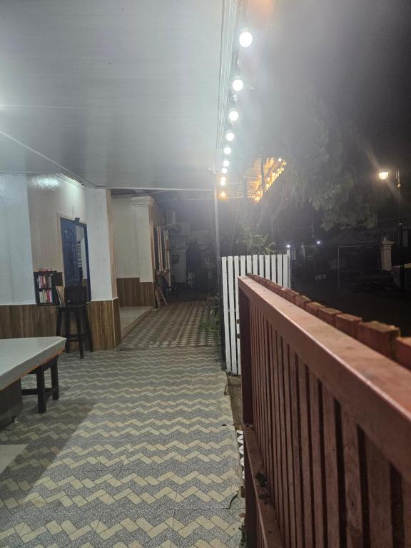 a room with a wooden fence and a table and a table at LPQ Hostel in Luang Prabang