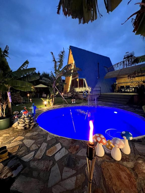 a lit candle in front of a pool at night at Blue Bungalow Of Cyprus 