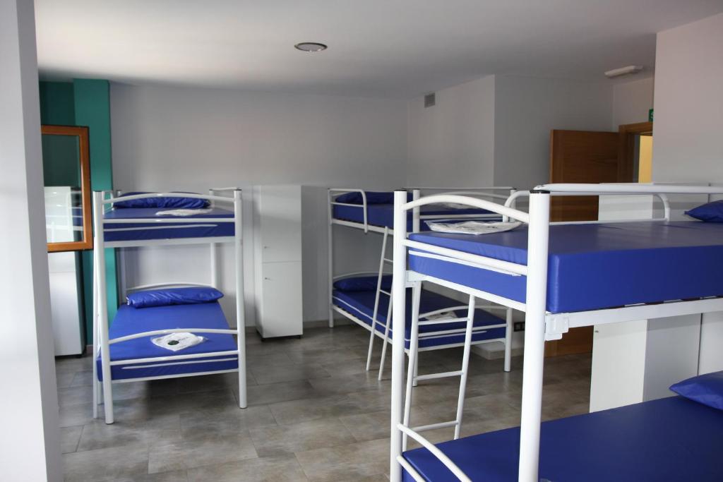 a group of bunk beds in a room at Albergue Outeiro in Palas de Rei 