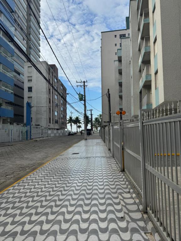 an empty street with a fence and buildings at Apartamento Fb in Água Boa