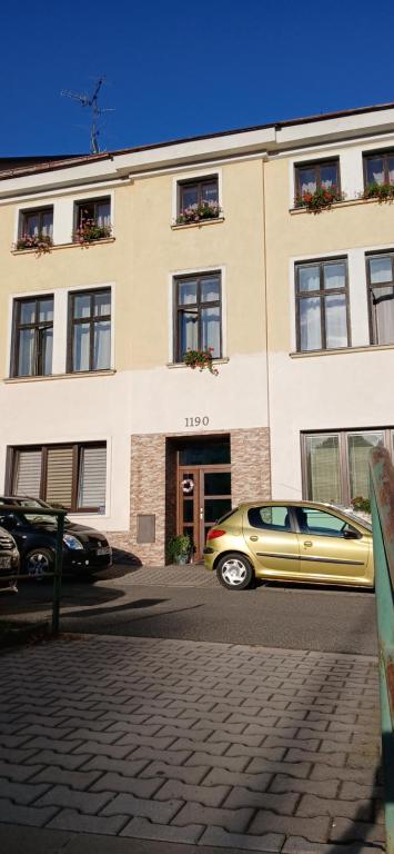a yellow car parked in front of a building at Apartmán Maršík in Náchod