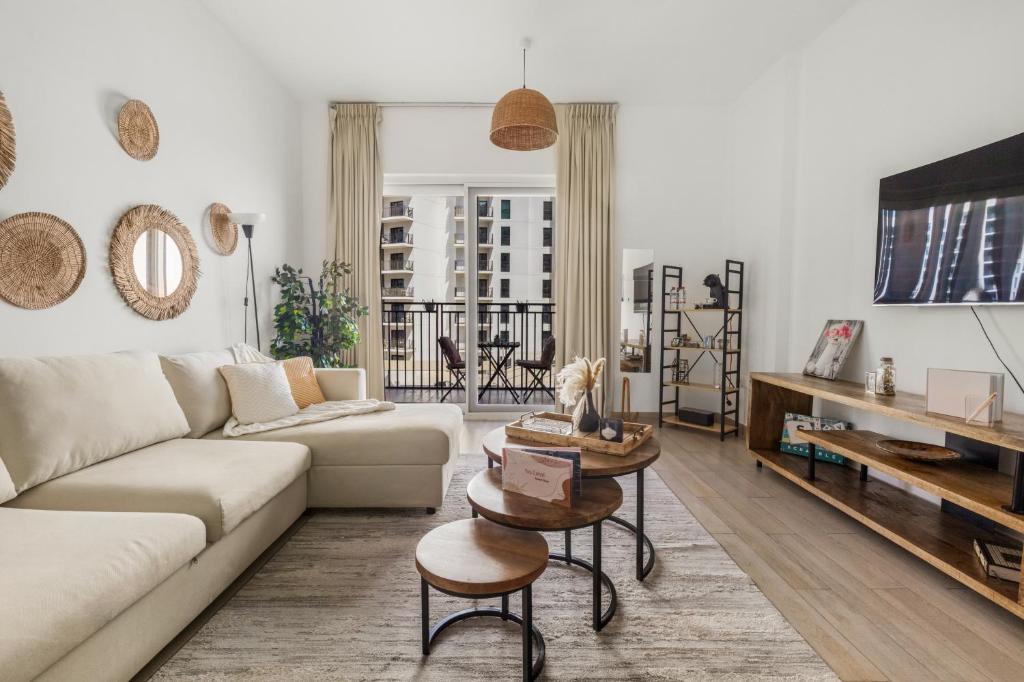 una sala de estar con un sofá y una mesa en Waterfront Yas 1br Near F1 & Ticket Savings, en Yas Island