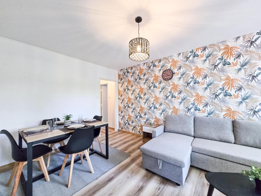 a living room with a couch and a table at Carl'Apartment4 Professionnel Famille WIFI parking in Carling