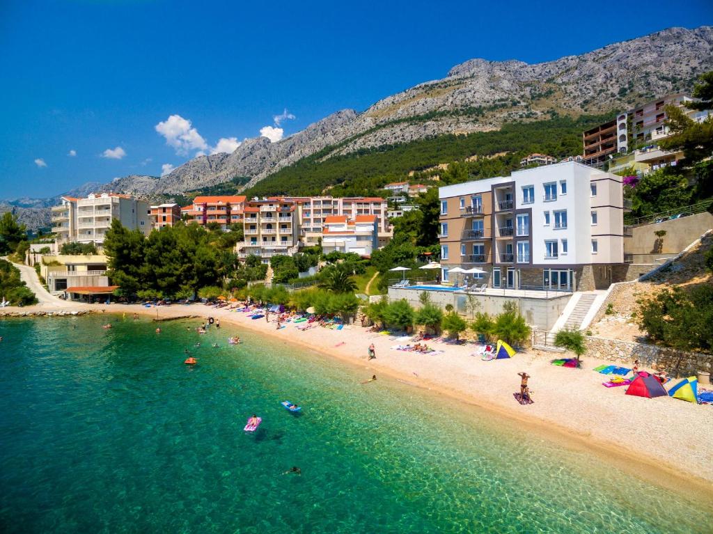 a beach with a bunch of people in the water at Villa Veronika in Omiš
