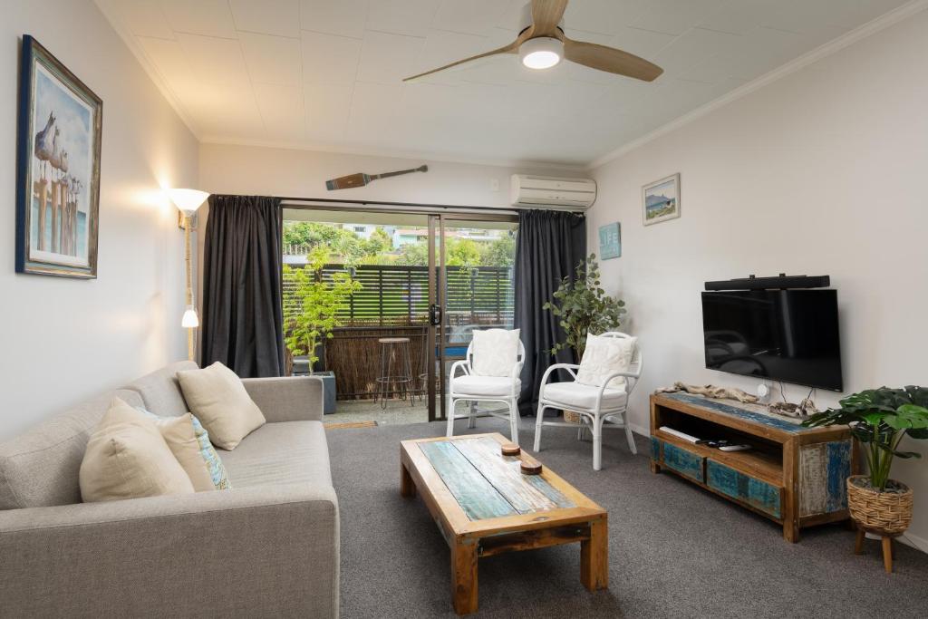 a living room with a couch and a tv at A Stone's Throw in Picton