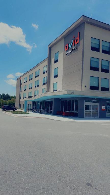 a large building with a sign on the side of it at Avid Hotel in Macon