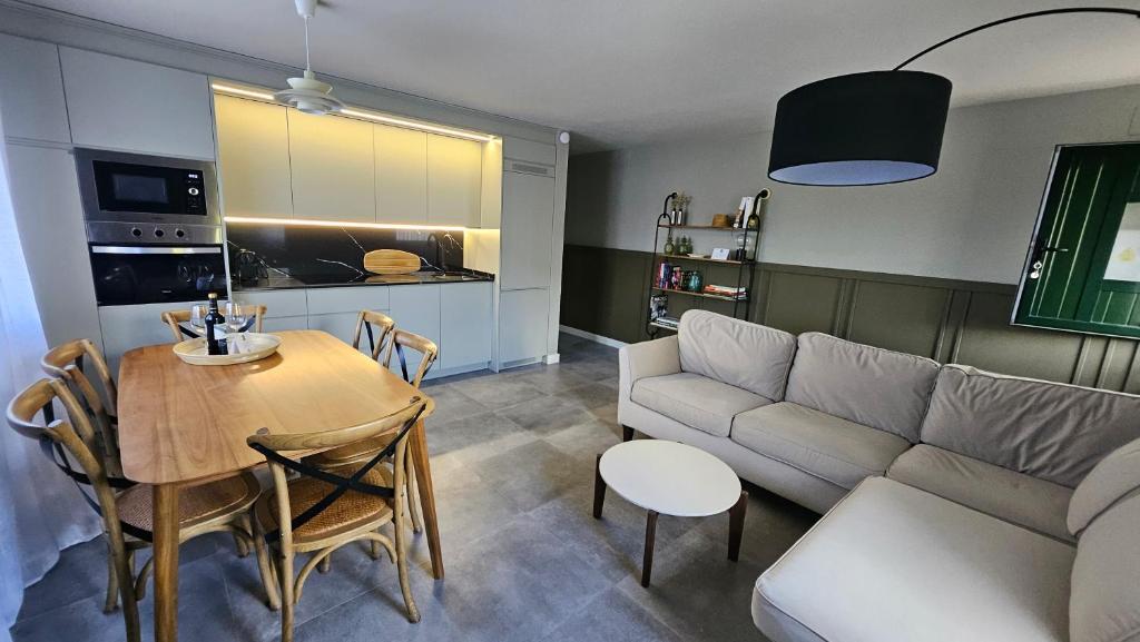 a living room with a table and a couch and a table and chairs at Casa Candeleda Alojamiento Boutique in Candeleda