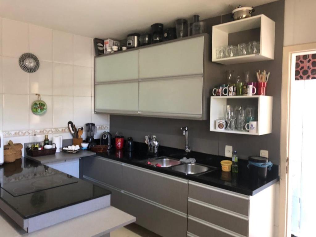 a kitchen with a sink and a counter top at Casarão da Brisa in Ilha do Tatu