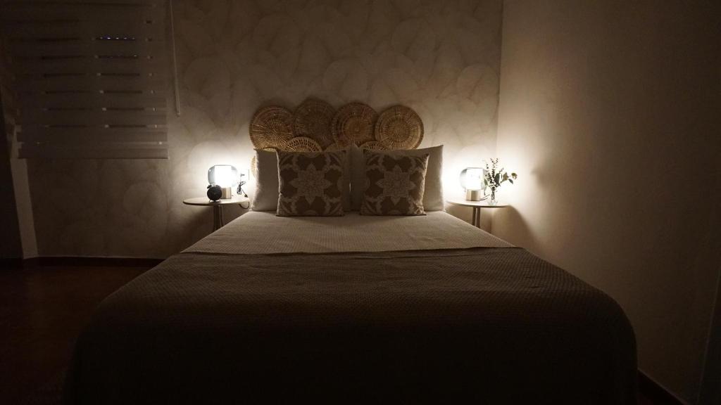 a bedroom with a large bed with two lamps at El rinconcito in Benaocaz