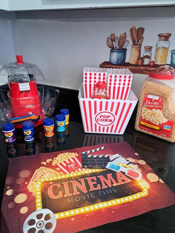 a table with a box of popcorn and a basket of food at Fun Home in Pocono with Gameroom-Firpit-BBQ Grill-TV and AC in all rooms in Tobyhanna