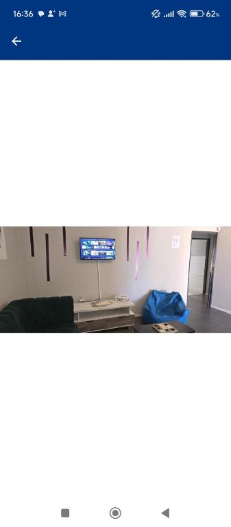 a screenshot of a room with a tv and a desk at Vacation Home in Vanderbijlpark