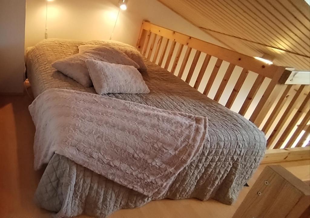 a bed with two pillows on it in a room at Ruska Levi - Cozy Apartment in the Center in Levi