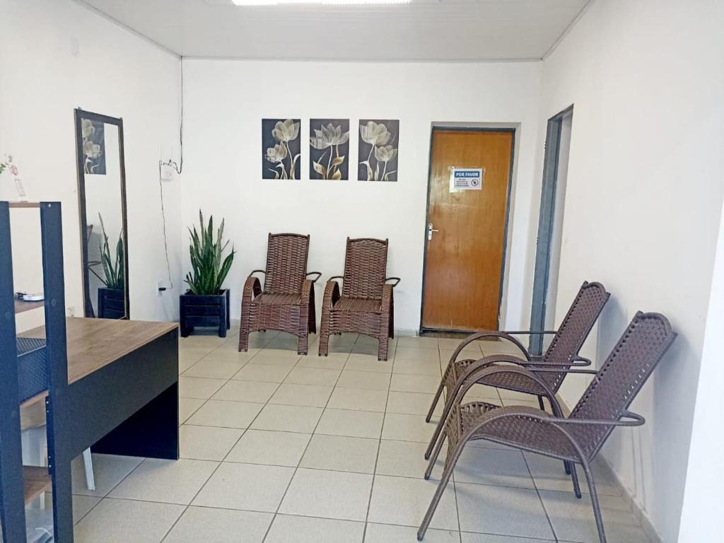 a group of chairs and a table in a room at Hostel JK in Bom Jesus