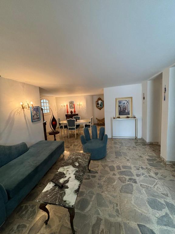 a living room with a couch and a table at évasion bleu in Dar Salah Bey