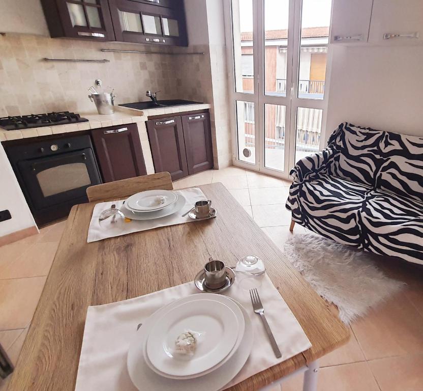 a kitchen with a table with a plate on it at Residenza IV Novembre in Settimo Torinese