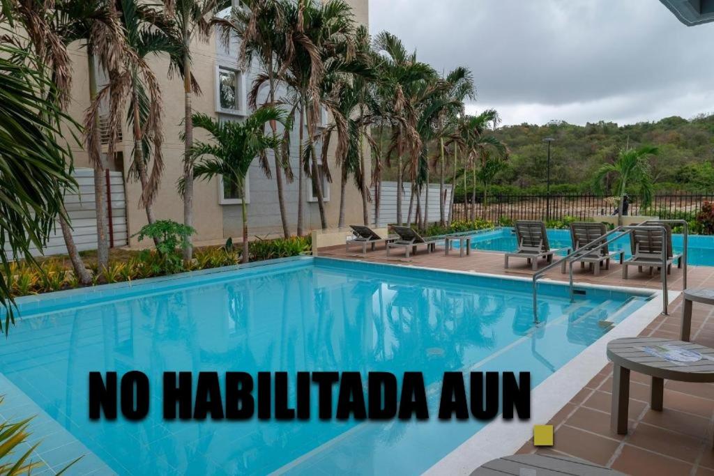 a swimming pool with a sign that reads no hacienda inn at Apartamento Cartagena Moderno y Comodo in Manzanillo del Mar