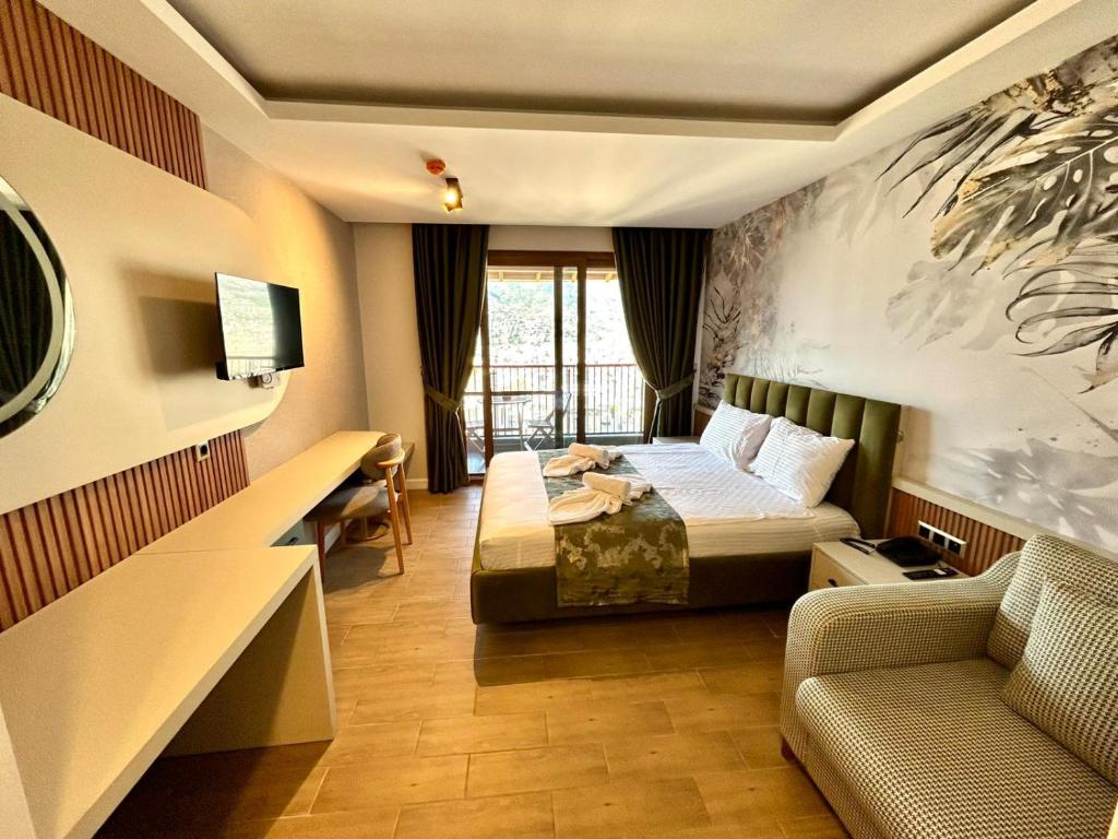 a hotel room with a bed and a couch at Castello By Mediterra Hotel in Alanya