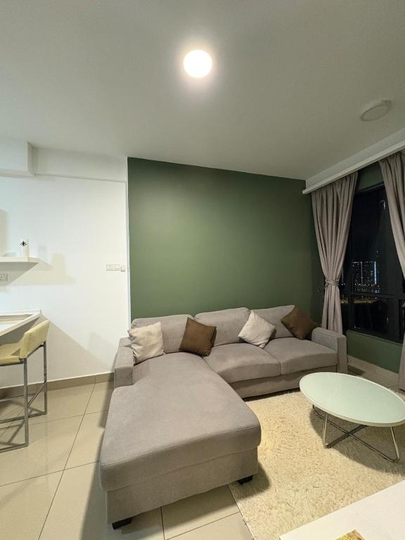 a living room with a couch and a table at Eclipse Residence in Cyberjaya