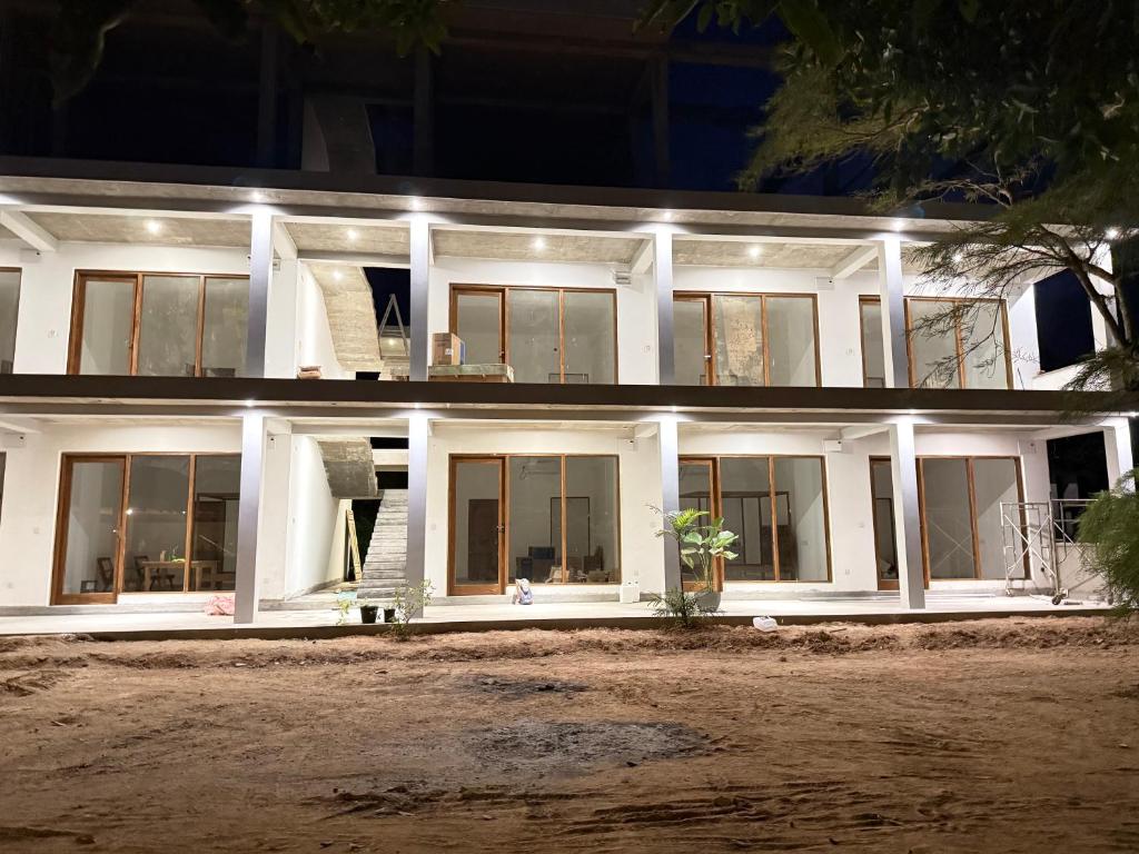 a white house with windows at night at Lily Mirissa in Mirissa