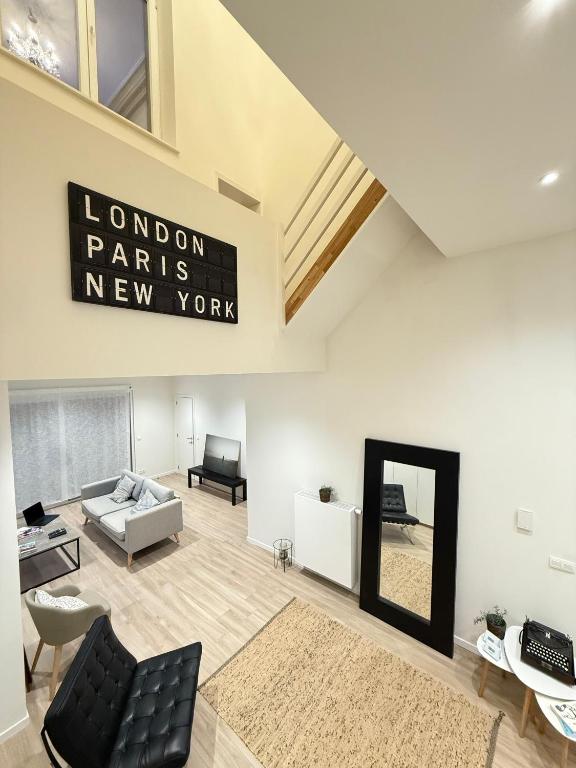 a living room with a sign that reads london paris new work at The Gallery Saint-Gilles in Brussels