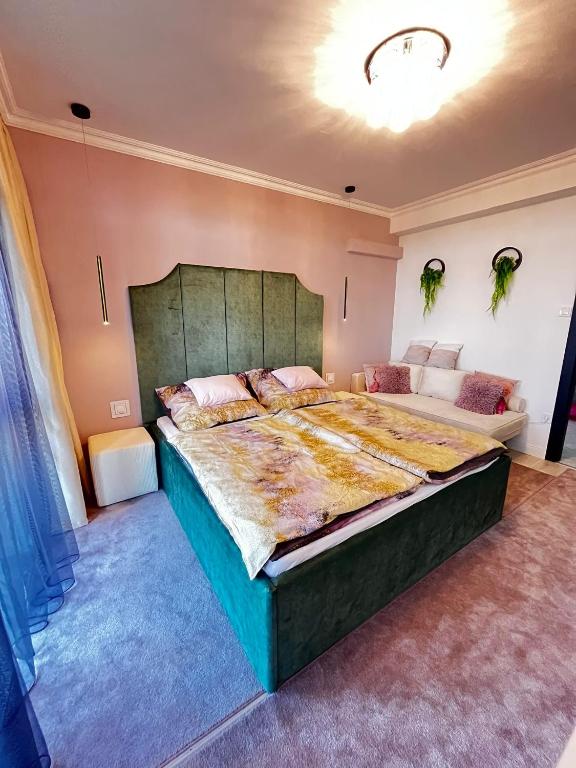 a bedroom with a large bed in a room at Violet Suite in Nyíregyháza